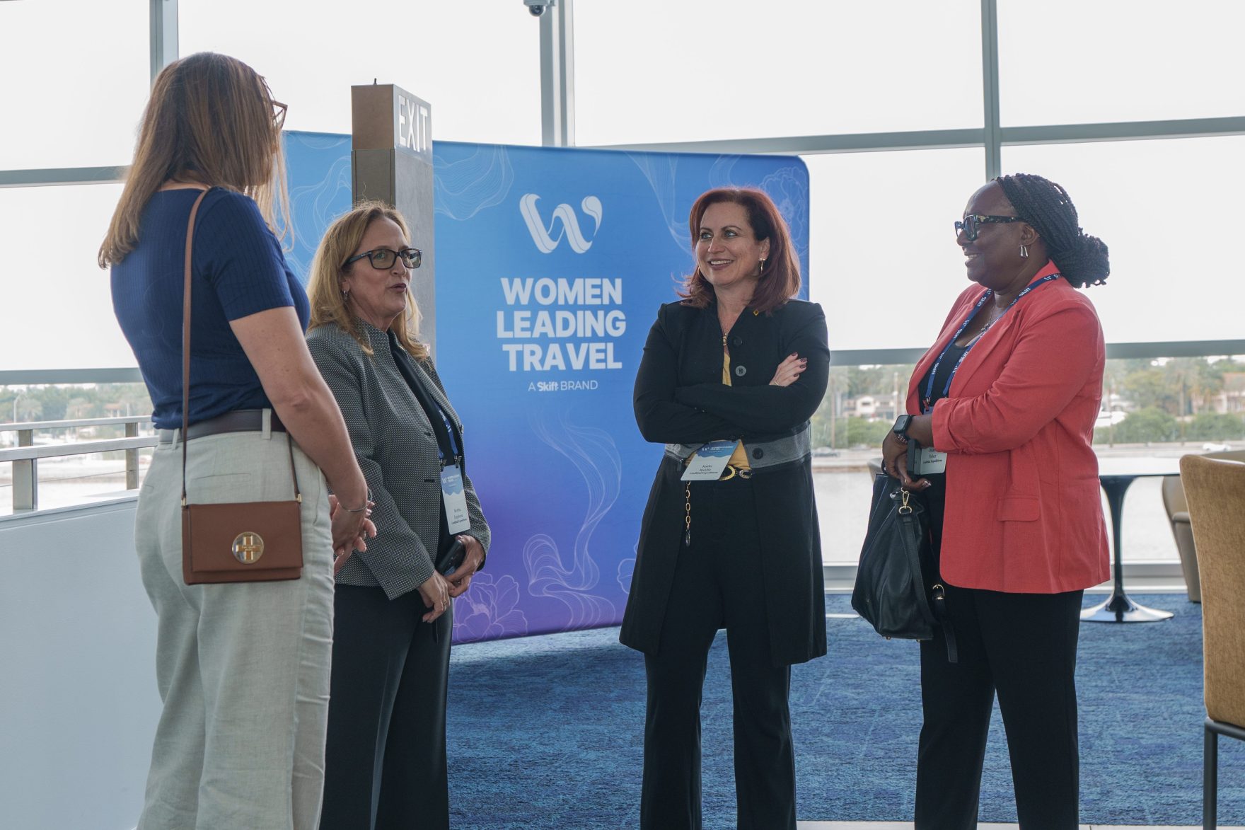a group of women interacting at women leading travel forum